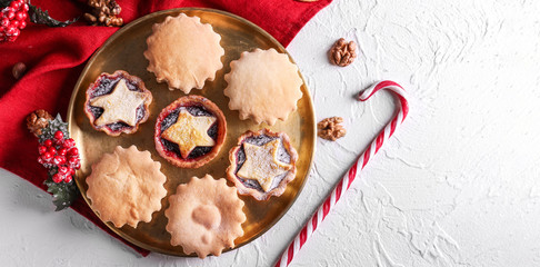 Plate with tasty mince pies on table