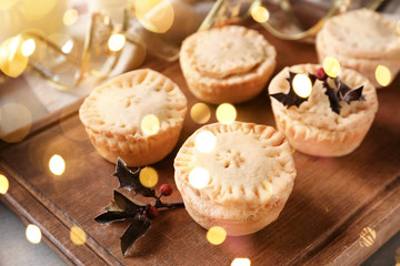 Tasty mince pies on wooden board