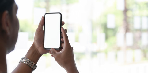 Cropped shot of businessman holding blank screen smartphone