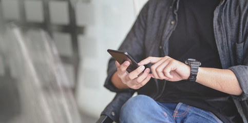 Close-up of young professional businessman checking his schedule on smartphone