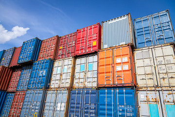 The territory of the container freight yard:a lot of metal containers for storing goods of different colors, stacked in rows on top of each other.Conception of storage of goods by importers, exporters