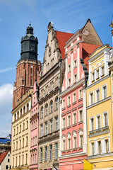 Multi colored houses with St. Elizabeth's Church in the back seen in Wroclaw, Poland