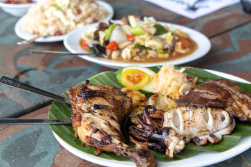Pork, Squid, Chicken, Fish Filipino Barbecue on the Banana leaf plate
