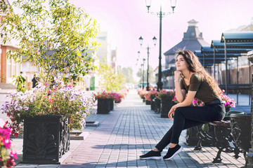 Young adult beautiful brunette girl in casual clothes happy on city street