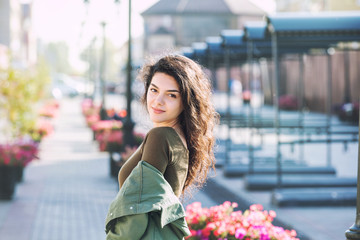 Young adult beautiful brunette girl in casual clothes happy walking around the city