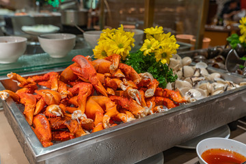 Pile of crab claws and clams in seafood buffet restaurant