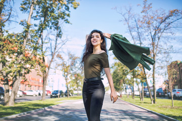 Young adult beautiful brunette girl in casual clothes happy walking around the city