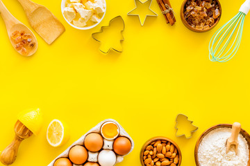 Kitchen frame. Dough ingredients and crockery on yellow background top view copy space