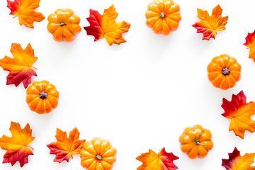 Autumn background with leaves and pumpkins on white top view copy space frame