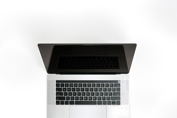 Open laptop with blank screen on white background top view