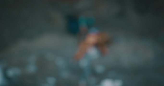 Rock climber falling off of rock wall in slow motion going out of focus