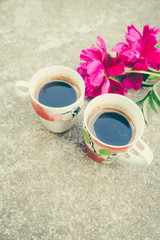 Two cup coffee and peony flowers