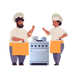 cooks couple professional chefs preparing and tasting dishes african american woman man restaurant workers in uniform standing together near kitchen stove cooking food concept flat full length