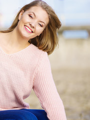 Woman in sweater walking on beach