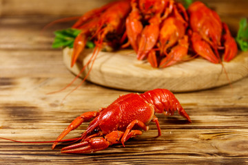 Boiled crayfish on cutting board on wooden table