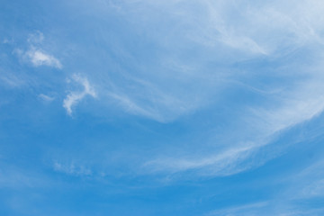 Bright blue sky with white soft motion clouds