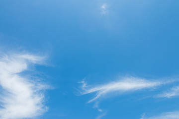 Naklejka na ściany i meble Bright blue sky with white soft motion clouds