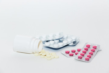 The medicine. Prevention of colds and flu. Multi-colored pills for treatment on a white background. Top view. Flat lay on a medical theme.