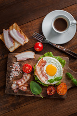 Fried eggs with bacon and vegetables
