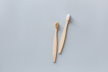eco natural bamboo toothbrushes flat lay on gray background. sustainable lifestyle concept. zero waste, plastic free items. stop plastic pollution. Top view, overhead, template, Mockup.
