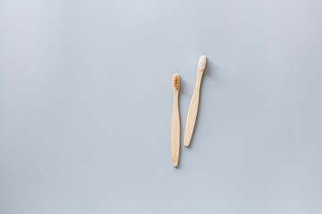 eco natural bamboo toothbrushes flat lay on gray background. sustainable lifestyle concept. zero waste, plastic free items. stop plastic pollution. Top view, overhead, template, Mockup.