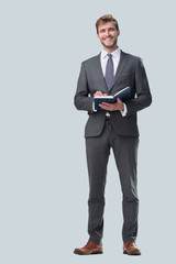 in full growth. successful businessman with a notebook.