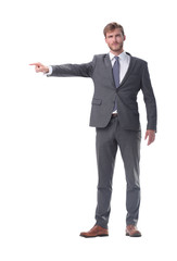 in full growth. serious businessman pointing to the side.