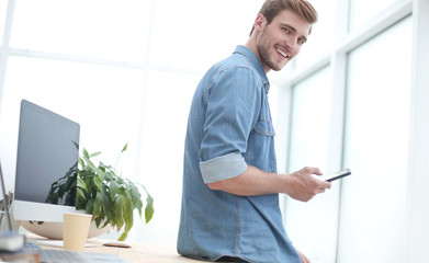 young businessman choosing a contact in his smartphone.