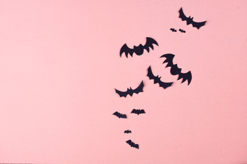 Halloween party content. Black bats of different sizes on a plain background.