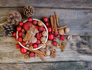 basket with Christmas toys and walnuts. festive traditional composition. winter season concept. Christmas winter decor and nuts on wooden table. Christmas and New Year Holiday background. soft focus