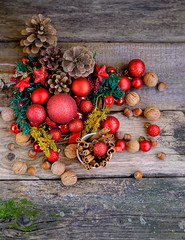 basket with Christmas toys and walnuts. festive traditional composition. winter season concept. Christmas winter decor and nuts on wooden table. Christmas and New Year Holiday background. Top view