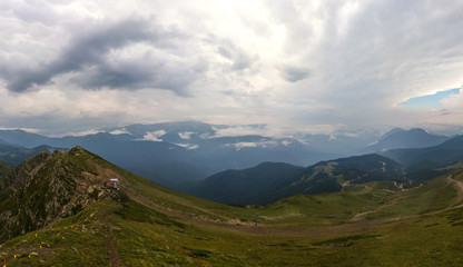 Obraz na płótnie Canvas mountain landscape on a cloudy summer day - panorama over the observation deck on the top of Kamenny Pillar (2502m) - Aibga mountain range, Western Caucasus, South of Russia