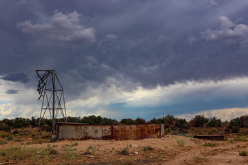 Broken windmill abandoned in the Arizona desert before a storm