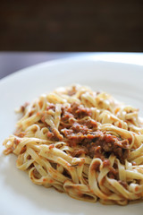 spaghetti Bolognese with minced beef and tomato sauce garnished with parmesan cheese and basil , Italian food