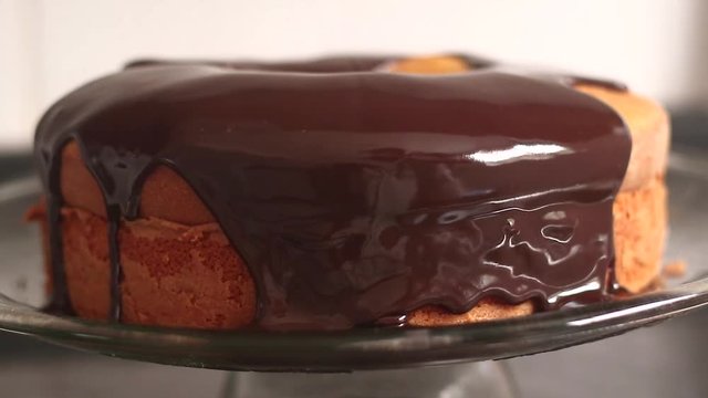Chocolate icing on carrot cake. Chocolate glaze pouring on homemade cake. Brazilian carrot cake. Topping chocolate on carrot cake. June Partys sweet
