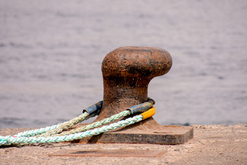 Rusty metal mooring bolard for big ship