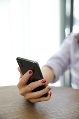 Woman hand using smart phone in business