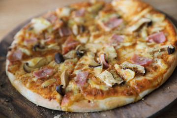 pizza ham and mushroom on wood background