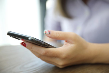 Woman hand using smart phone in business