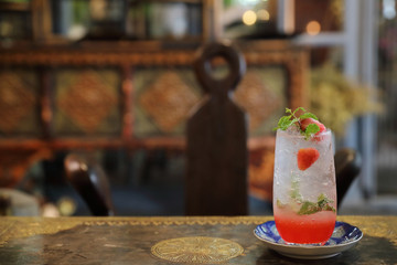 Strawberry mojito cocktail drink on wood background