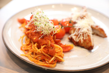 Spaghetti bolognese tomato sauce with fried chicken ,