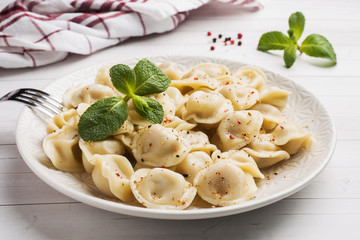 Dumplings stuffed with meat, ravioli, dumplings. Dumplings with stuffing. Russian cuisine.