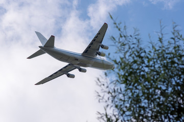 huge cargo transport plane takes off in the sky