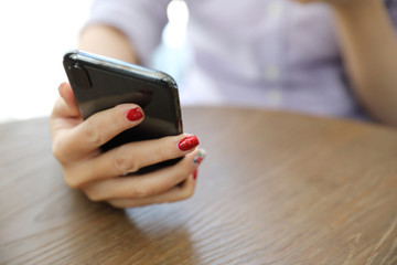 Woman hand using smart phone in business