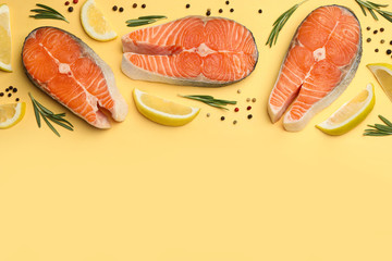 Flat lay composition with salmon steaks on yellow background. Space for text