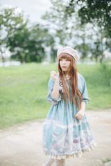 Portrait of asian girl in lolita fashion dress in garden background