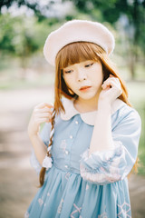 Portrait of asian girl in lolita fashion dress in garden background