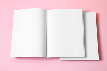 Empty book pages on pink background, top view. Mockup for design