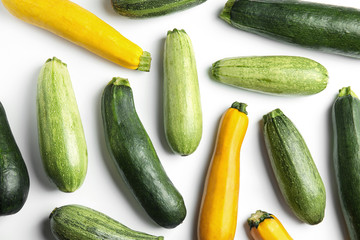 Fresh ripe zucchinis on white background, top view