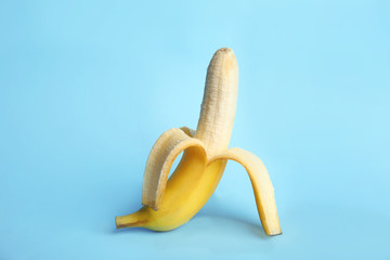 Fresh banana on light blue background. Sex concept